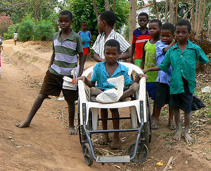 Earnest coming home from school in his wheelchair