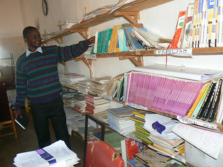 Wilson points to bookshelves delivered to school