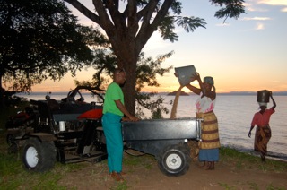 Women Loading Sand on V-Tractor Trailer