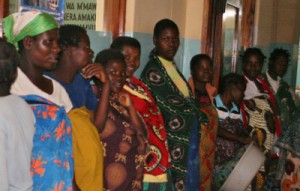 LIne of women waiting a delivery table