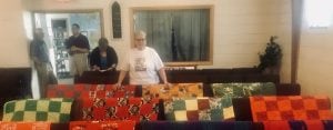 Quilts draped over the pews in a church