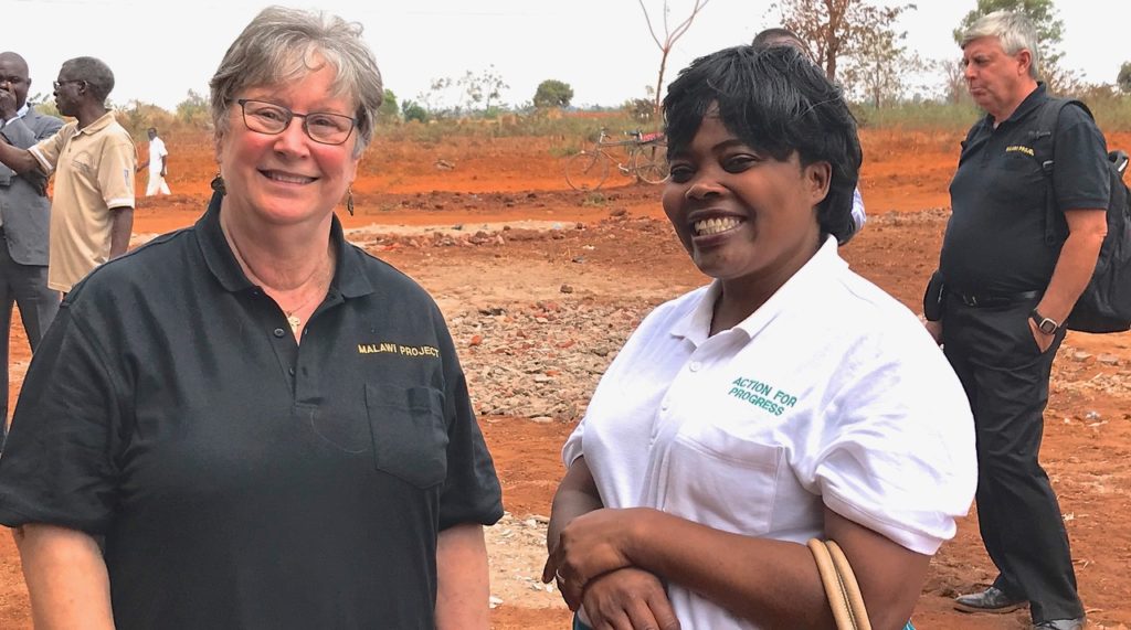 Suzi Stephens standing with Madalitso Mwandoloma, Medical Director for Action for Progress