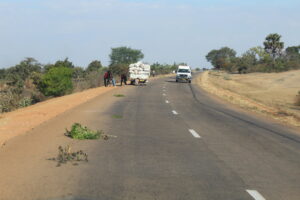 Cars trying to stay in their lanes on a narrow road