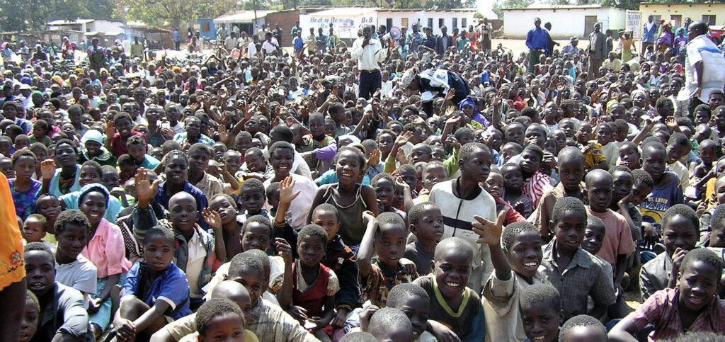 portion of the 5,000 orphan children gathered at the Mponela Trading Center a few years ago to receive food during the intense famine