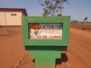 Road sign reading Action For Progress